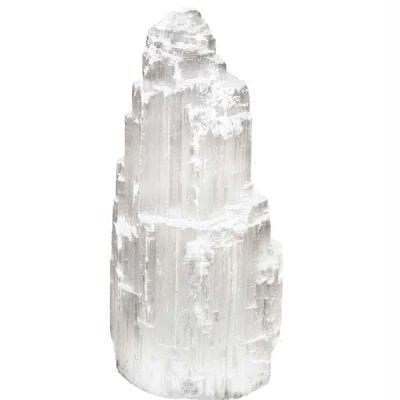 Selenite white crystal tower stands 4 inches high with grey highlights to cleanse room and absorbe negativity for positive environment. Photographed in Let It Go with Reiki clinic. 